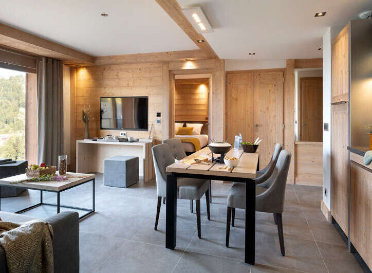 This stunning apartment boasts a spacious open-plan living area with floor-to-ceiling windows offering breathtaking mountain views.