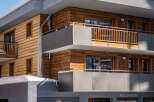The Manaka Hotel boasts a stunning modern design, featuring a striking combination of wood and gray accents.