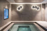 Indulge in tranquility at this luxurious spa, featuring a pristine indoor hot tub nestled within a sophisticated, tiled setting.