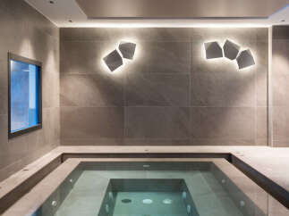 Indulge in tranquility at this luxurious spa, featuring a pristine indoor hot tub nestled within a sophisticated, tiled setting.