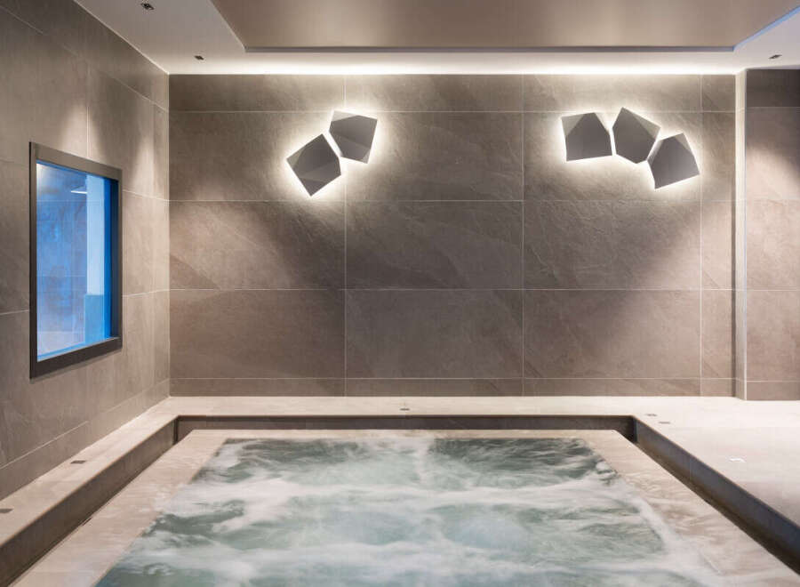 Relax and rejuvenate in this luxurious spa featuring a modern hot tub.