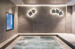 Relax and rejuvenate in this luxurious spa featuring a modern hot tub.