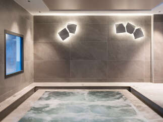 Relax and rejuvenate in this luxurious spa featuring a modern hot tub.