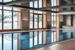 Indulge in the serene indoor pool, boasting floor-to-ceiling windows showcasing breathtaking snowy mountain views.