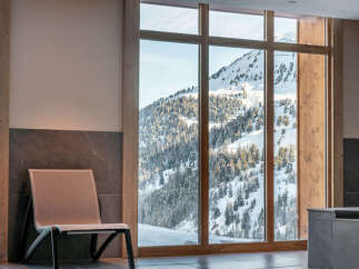 Indulge in the ultimate relaxation experience at our luxurious hotel, boasting a stunning indoor pool with breathtaking mountain views.