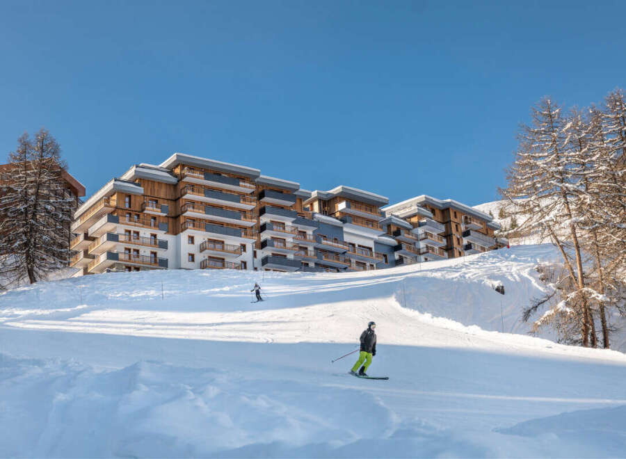 Luxury ski-in/ski-out apartments in the French Alps, offering breathtaking mountain views and direct access to the slopes.