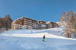 Luxury ski-in/ski-out apartments in the French Alps, offering breathtaking mountain views and direct access to the slopes.