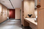 This modern locker room features sleek wooden lockers and a stylish design.