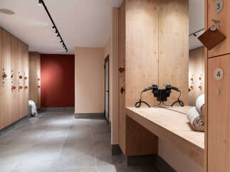 This modern locker room features sleek wooden lockers and a stylish design.