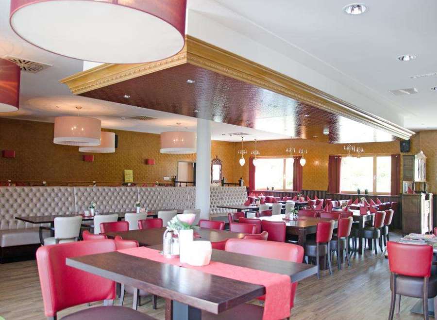 Step into a beautifully designed restaurant with a warm and inviting atmosphere.