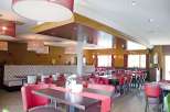 Step into a beautifully designed restaurant with a warm and inviting atmosphere.