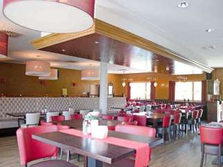 Step into a beautifully designed restaurant with a warm and inviting atmosphere.