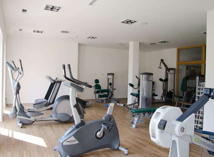 Step into a state-of-the-art fitness center, fully equipped to meet all your workout needs.