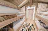 Discover the charm of this cozy cabin interior, featuring rustic wooden bunk beds perfect for a family getaway.
