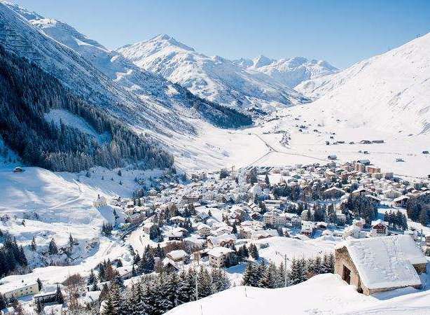 Experience the charm of a snow-covered village nestled in a picturesque mountain valley.