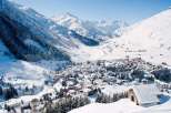 Experience the charm of a snow-covered village nestled in a picturesque mountain valley.