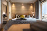 This luxurious bedroom boasts a stunning wood-paneled wall, creating a warm and inviting atmosphere.