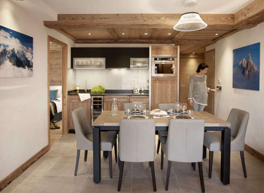 This stunning apartment boasts a spacious open-plan living area with a modern kitchen and dining space, perfect for entertaining guests.