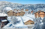 Discover luxurious chalets nestled in a breathtaking snowy mountain setting.