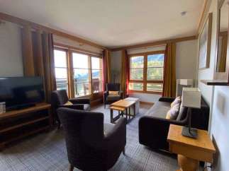 Enjoy stunning mountain views from this cozy living room.