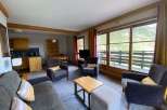 Discover a cozy living space with a comfortable sofa and armchairs, perfect for relaxation.