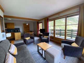 Discover a cozy living space with a comfortable sofa and armchairs, perfect for relaxation.