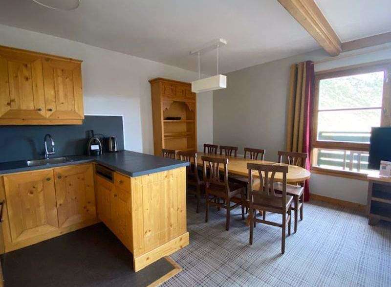 This charming property features a well-equipped kitchen with wooden cabinetry and a sleek countertop.