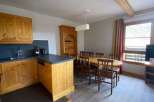This charming property features a well-equipped kitchen with wooden cabinetry and a sleek countertop.