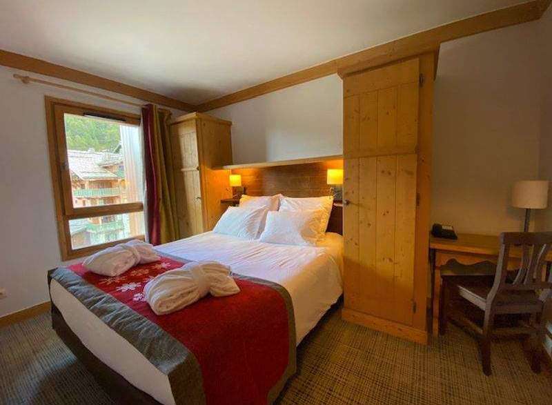 Cozy up in this charming bedroom featuring a comfortable bed and inviting decor.