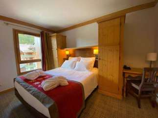 Cozy up in this charming bedroom featuring a comfortable bed and inviting decor.