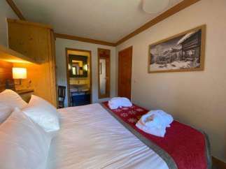 Cozy bedroom with a comfortable bed and soft pillows.