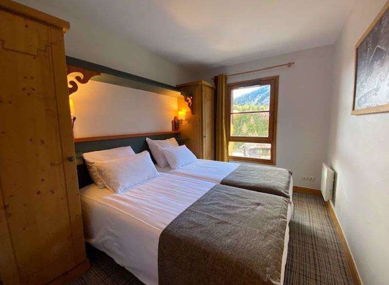 Cozy bedroom with two beds, perfect for a comfortable stay.