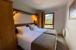 Cozy bedroom with two beds, perfect for a comfortable stay.