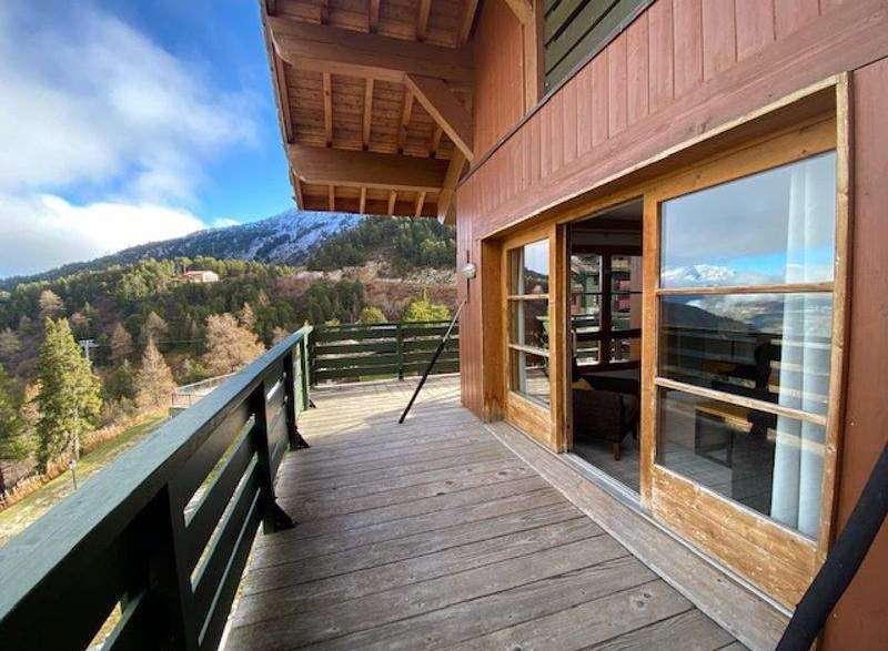 Enjoy breathtaking mountain views from this charming wooden balcony.