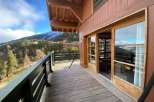 Enjoy breathtaking mountain views from this charming wooden balcony.