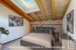 Discover the charm of this stunning bedroom, featuring a unique wooden ceiling and exposed beams that add character and warmth.