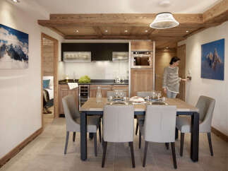 This stunning apartment boasts a spacious open-plan living area with a modern kitchen and dining space, perfect for entertaining guests.
