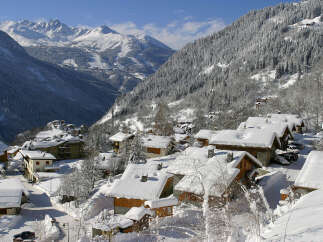 Nestled in a picturesque mountain village, this charming property offers stunning views of snow-capped peaks and a serene winter landscape.