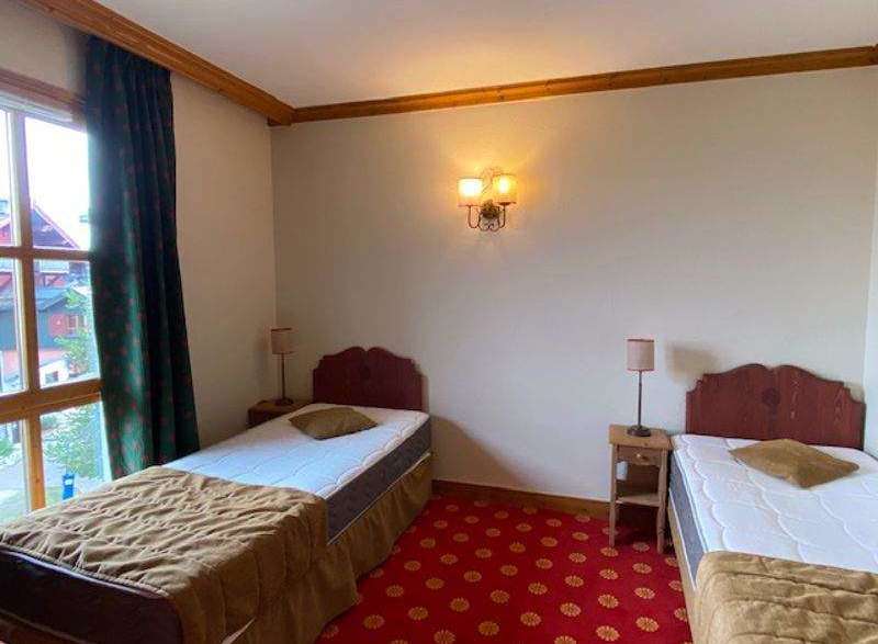 Cozy bedroom with two twin beds, perfect for a comfortable stay.