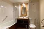 This bathroom features a classic design with a bathtub and a separate toilet area.