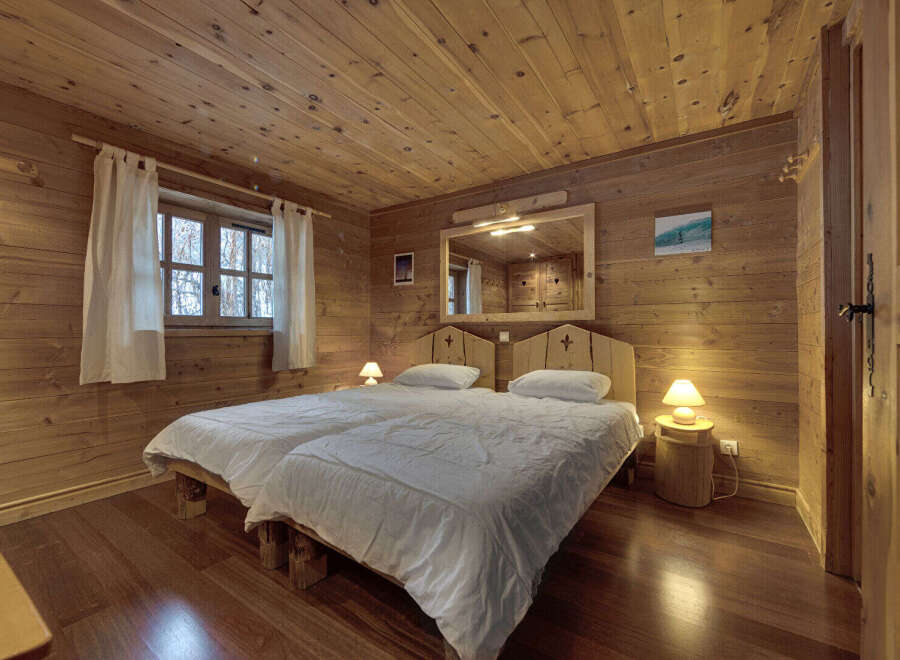 This cozy bedroom features a rustic wooden design, creating a warm and inviting atmosphere.