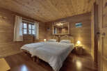 This cozy bedroom features a rustic wooden design, creating a warm and inviting atmosphere.