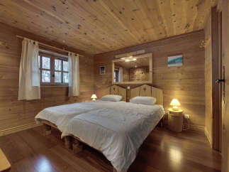This cozy bedroom features a rustic wooden design, creating a warm and inviting atmosphere.
