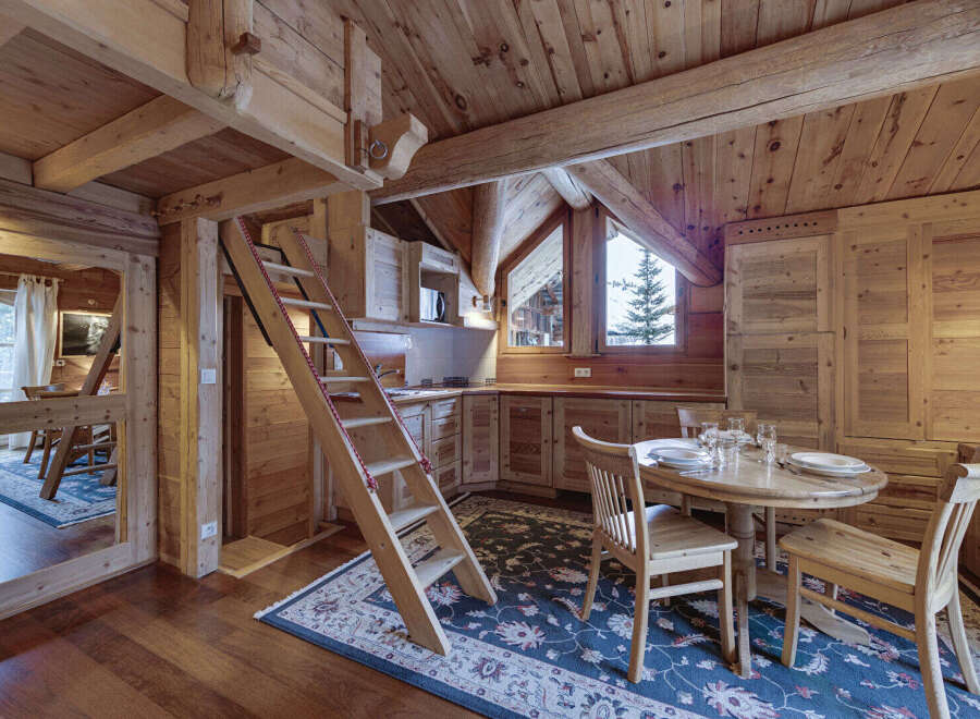This charming wooden cabin kitchen offers a cozy and inviting atmosphere.