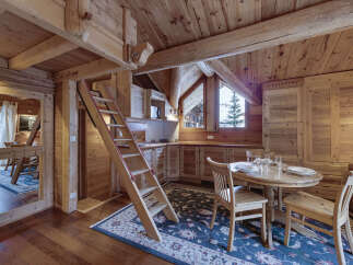 This charming wooden cabin kitchen offers a cozy and inviting atmosphere.