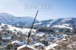 Sunlodge: A luxurious chalet nestled in the heart of a snow-covered alpine village.