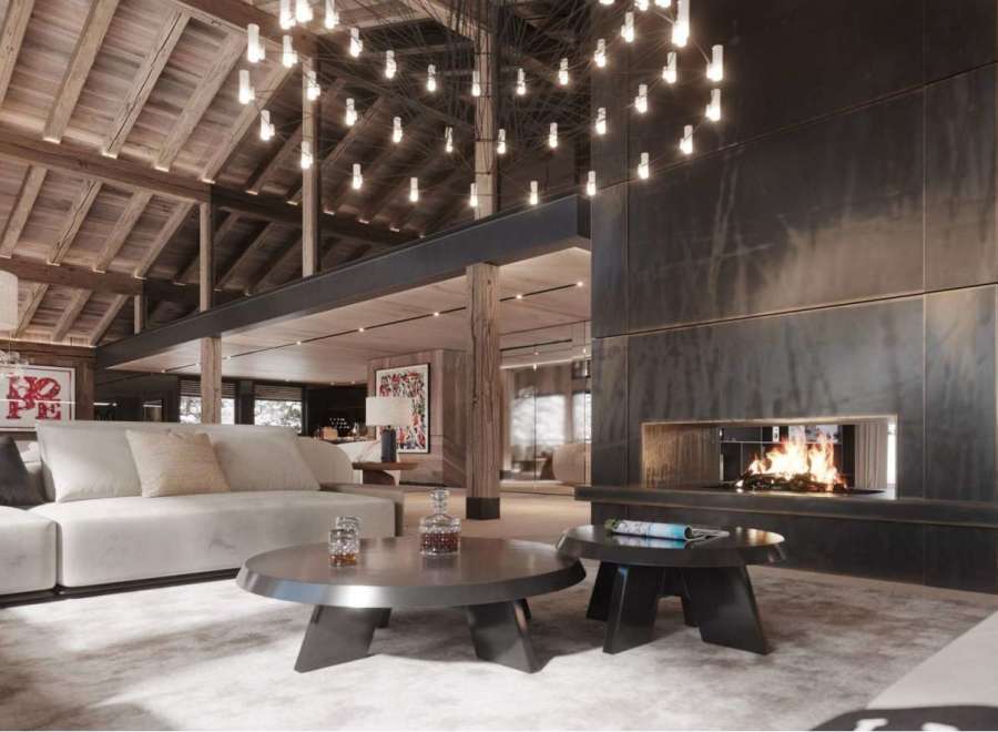 Luxury chalet with stunning wooden beams and a large metal fireplace.