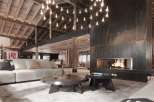 Luxury chalet with stunning wooden beams and a large metal fireplace.