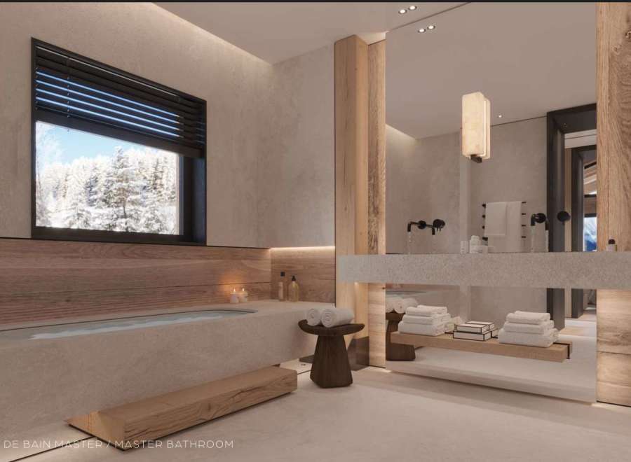 Luxurious master bathroom boasts a freestanding soaking tub, sleek floating vanity, and stunning mountain views.