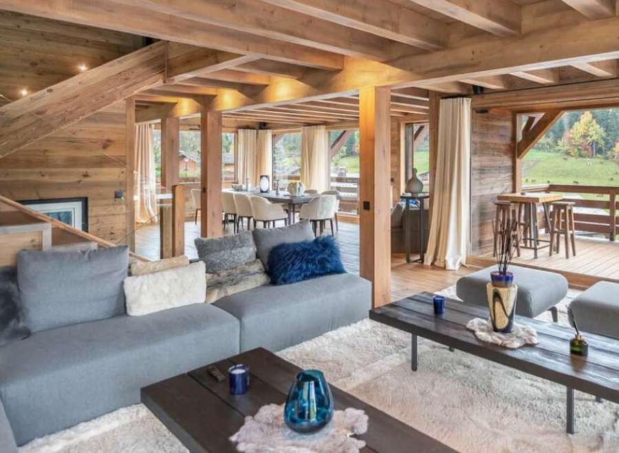This stunning chalet boasts a spacious open-plan living area with floor-to-ceiling windows offering breathtaking views.
